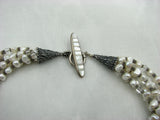 Sterling Silver and 5 strand White Pearl necklace.