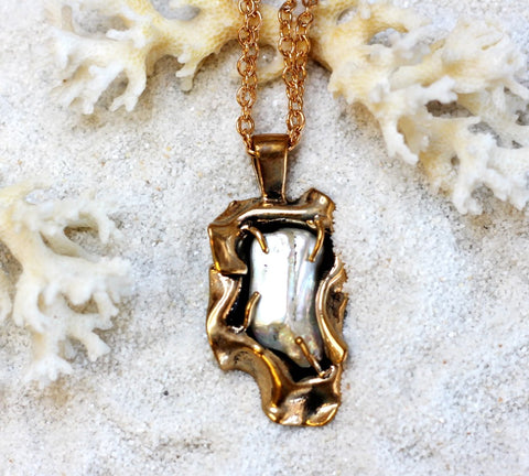 Baroque Pearl set in hand cast bronze wave form pendant.  084